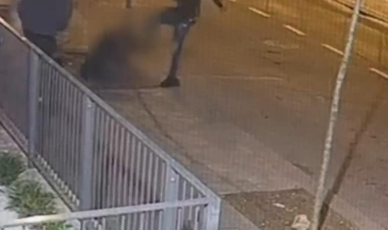 שני צעירים תוקפים אדם מוטל על הרצפה בשעת לילה, ברחוב מואר בשכונת גילה בירושלים – תיעוד ממצלמת אבטחה של אירוע שוד אלים