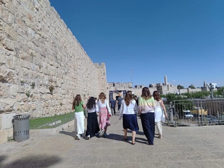 Group of women walking toward Jaffa Gate in Jerusalem under summer sun – representing the physical and spiritual journey to the Western Wall