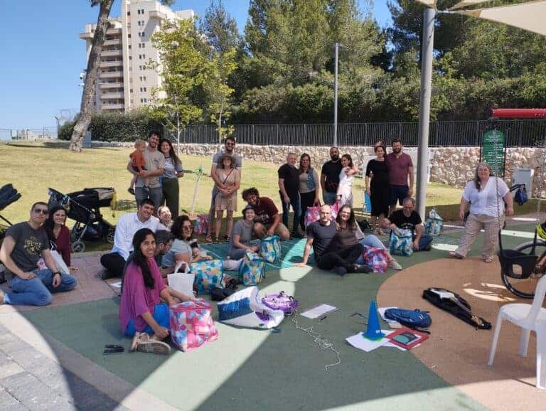 Community picnic in Jerusalem, neighbors gathering in a public park to build connections and improve wellbeing