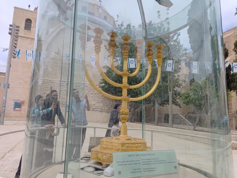 Golden menorah on display in Jerusalem’s Jewish Quarter, enclosed in glass