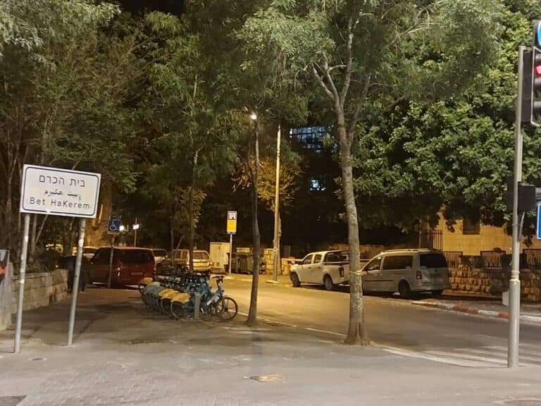 Street sign for “Bet HaKerem” in Jerusalem, captured at night. Scene of recent protests and growing secular unrest