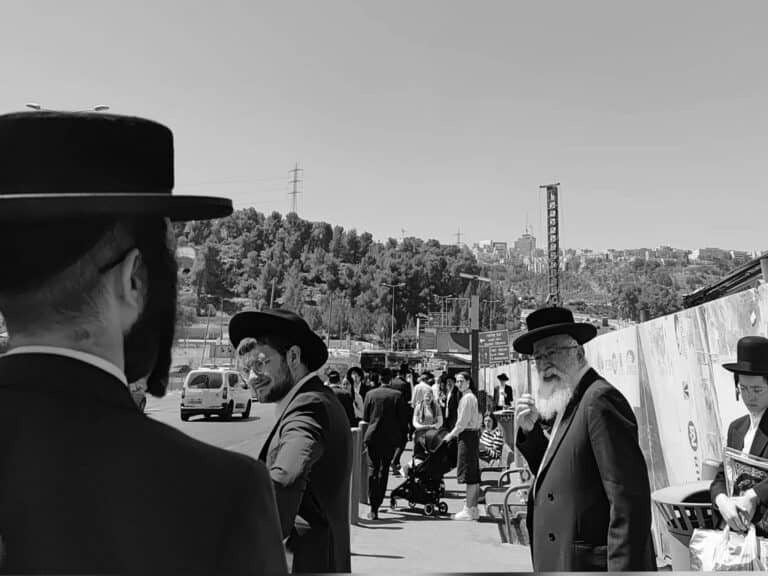 Crowded bus stop in Jerusalem during wartime driver shortage