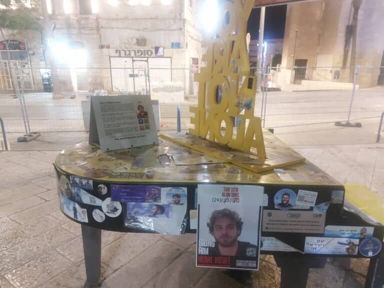 A yellow piano dedicated to hostage Alon Ahel stands abandoned in Jerusalem’s Safra Square, amid war and silence