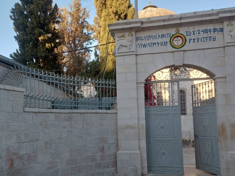 Entrance to the Ethiopian Church in Jerusalem, with traditional Ge'ez script and symbols of the Ethiopian monarchy, during wartime tension in June 2025