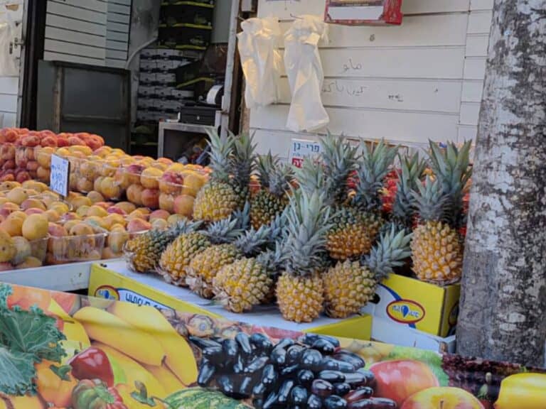 Pineapples on display at Mahane Yehuda market in Jerusalem, symbolizing summer, peace, and prosperity
