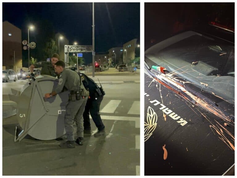 Settler youth lie on the road and splash paint during Jerusalem protest against police