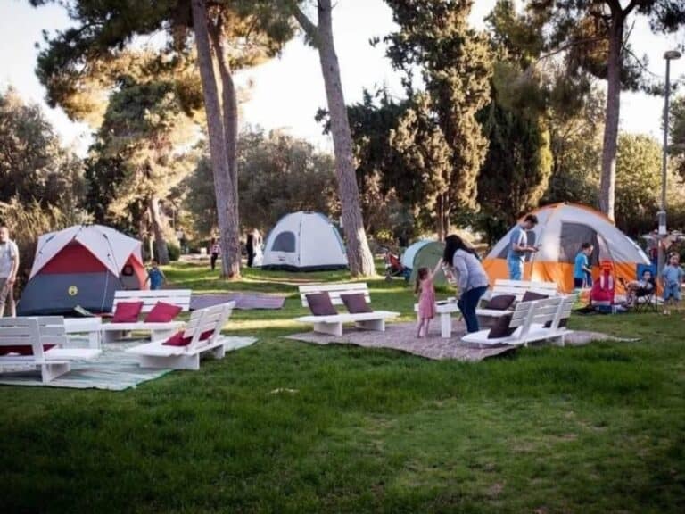 Tents and families gathered in a Jerusalem neighborhood park during a community camping night ar