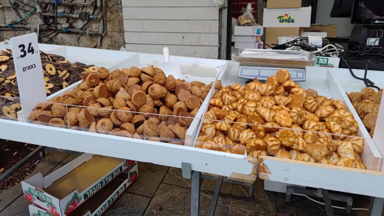 דוכן עוגיות לפסח בשוק מחנה יהודה בירושלים עם עוגיות קוקוס ובוטנים מסורתיות