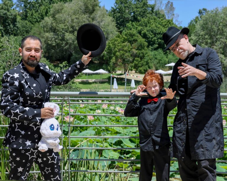 Magicians and a child at the “Magic in the Forest” event at the Jerusalem Botanical Garden
