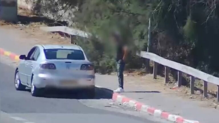 Suspected roadside drug transaction beside a vehicle in Jerusalem