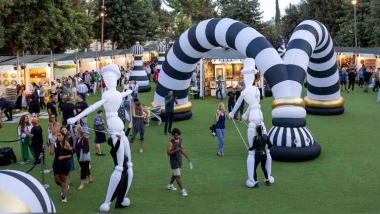 Visitors, art stalls and large installations at the Hutzot Hayotzer Festival in Jerusalem