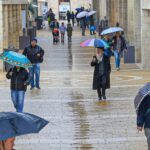 People walking with umbrellas in rainy Jerusalem ahead of winter 2026-2027